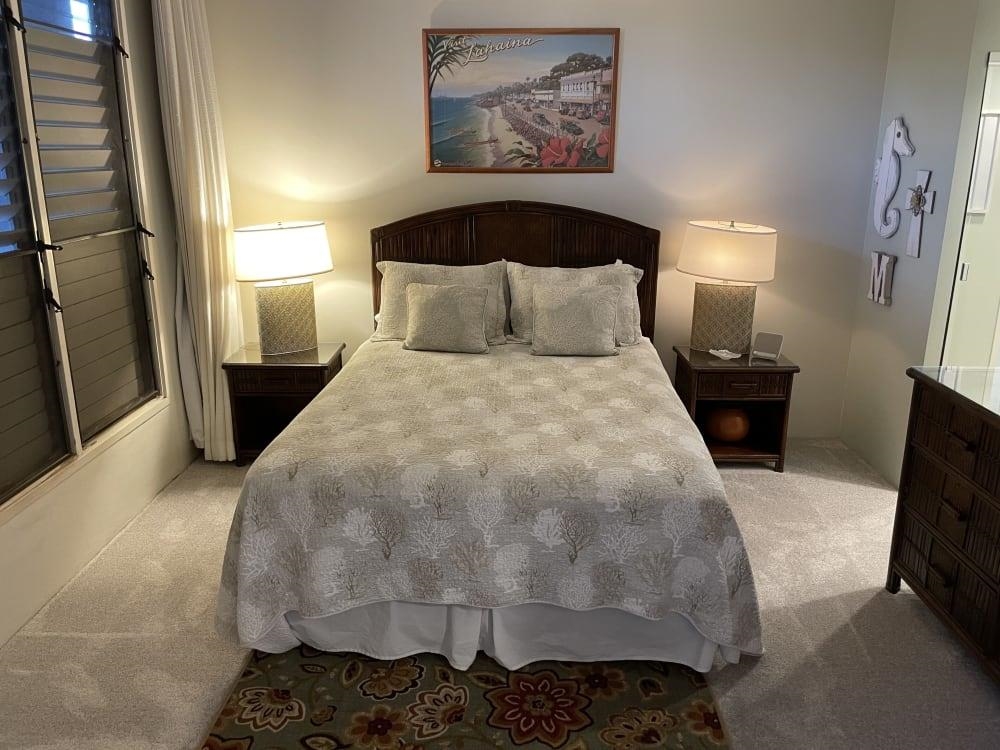 3875 Lower Honoapiilani Road, Unit A105 Lahaina, HI 96761 - Photo 12 of 27 a large bed sitting in a bedroom next to a lamp