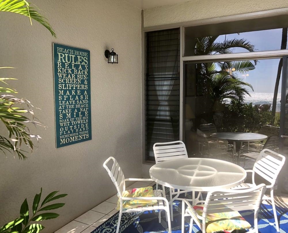 3875 Lower Honoapiilani Road, Unit A105 Lahaina, HI 96761 - Photo 19 of 27 a dining room with furniture and wooden floor