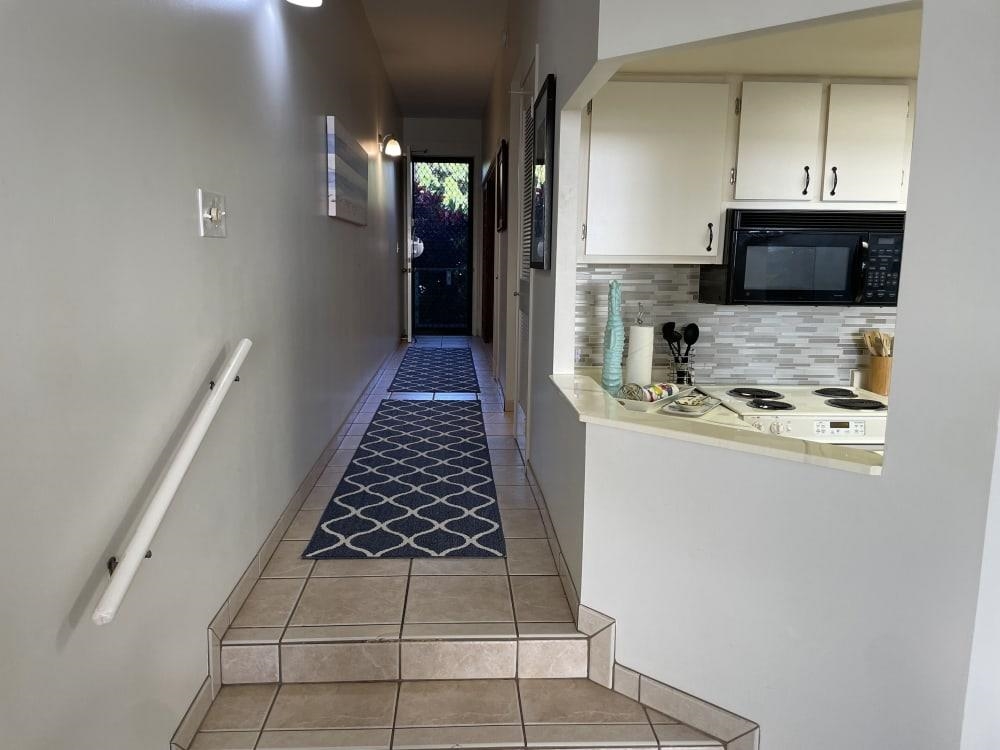 3875 Lower Honoapiilani Road, Unit A105 Lahaina, HI 96761 - Photo 5 of 27 a kitchen with white cabinets and appliances