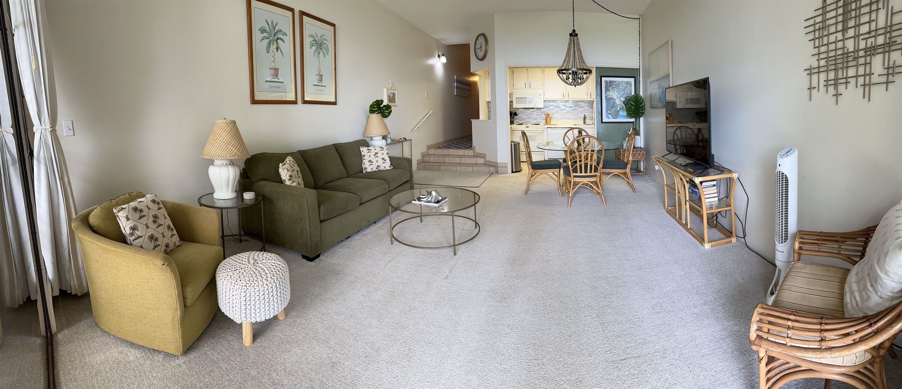 3875 Lower Honoapiilani Road, Unit A105 Lahaina, HI 96761 - Photo 7 of 27 a living room with furniture a flat screen tv and a floor to ceiling window
