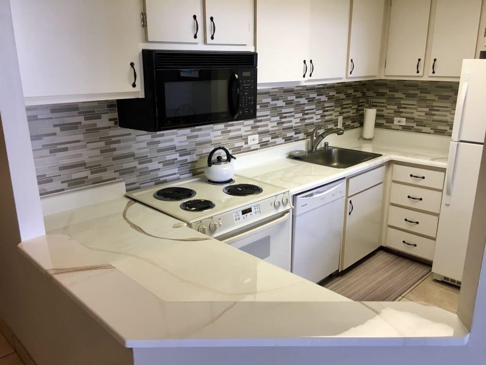 3875 Lower Honoapiilani Road, Unit A105 Lahaina, HI 96761 - Photo 10 of 27 a kitchen with a sink cabinets and appliances