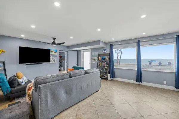 a bedroom with a bed a lamp and a flat tv screen