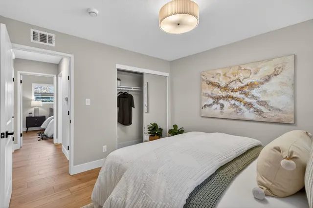a bedroom with a large bed and a chandelier