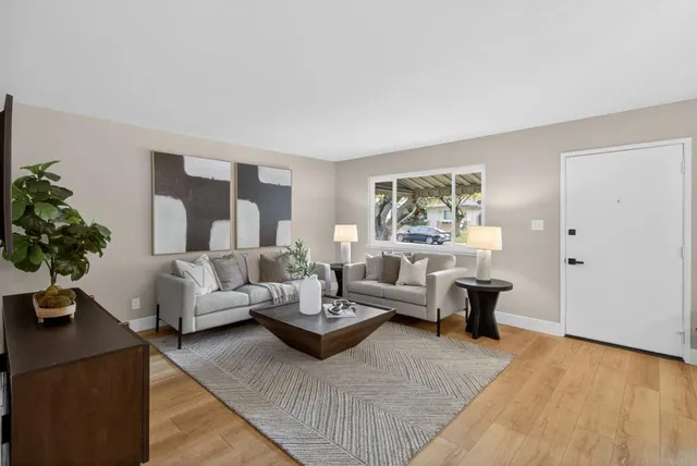 a living room with furniture and a large window