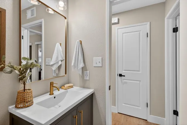 a bathroom with a sink vanity and a mirror