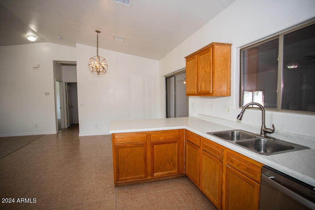 20526 West Teepee Road Buckeye, AZ 85326 - Photo 59 of 69 a kitchen with stainless steel appliances granite countertop a sink and a refrigerator