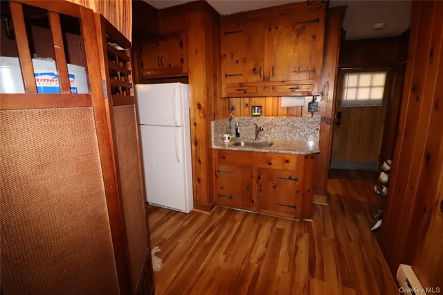 a kitchen that has a sink and wooden floor