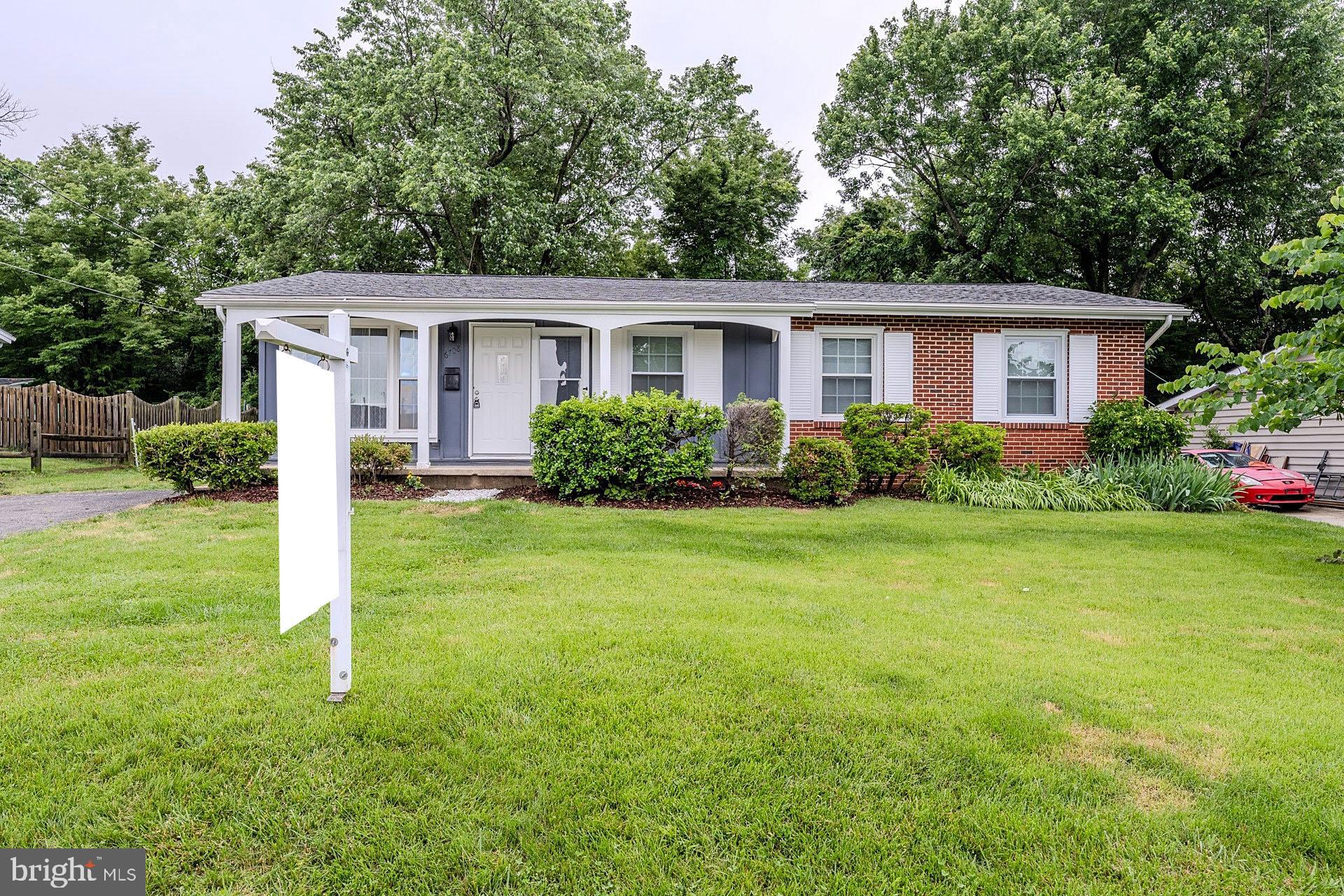 a view of a house with yard and a garden