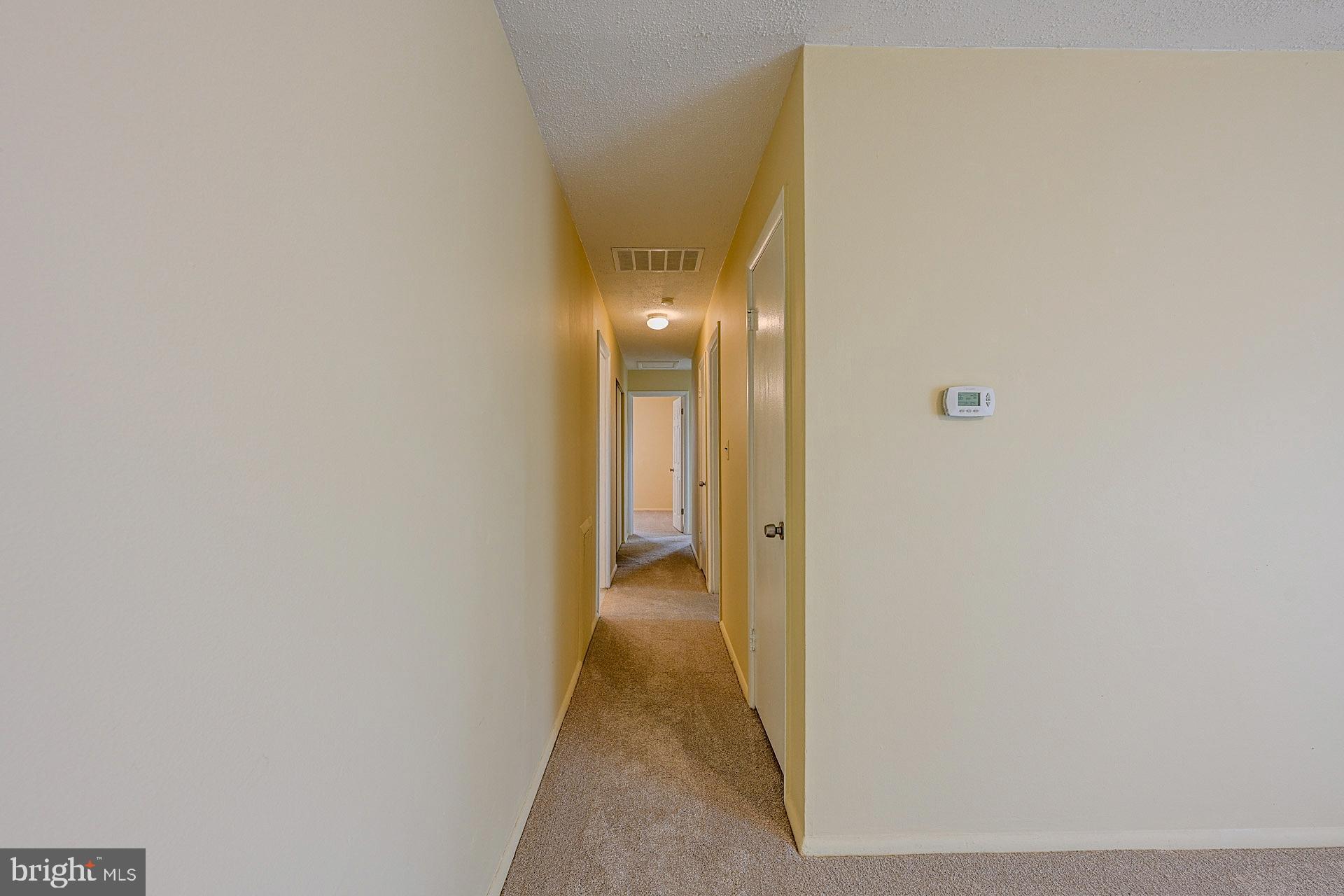6728 Bowie Drive Springfield, VA 22150 - Photo 13 of 26 a view of a hallway with wooden floor