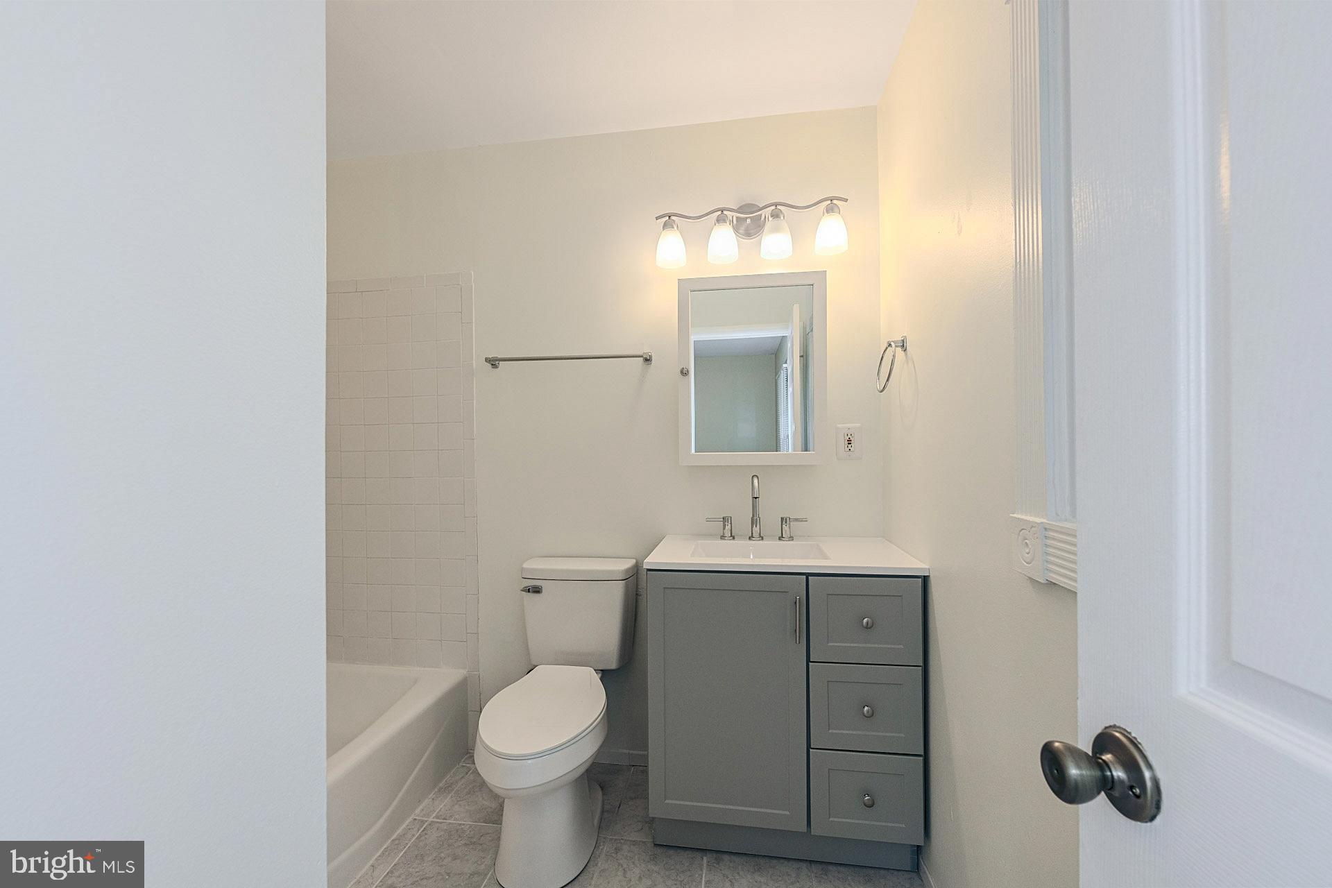6728 Bowie Drive Springfield, VA 22150 - Photo 16 of 26 a bathroom with a toilet a sink and mirror