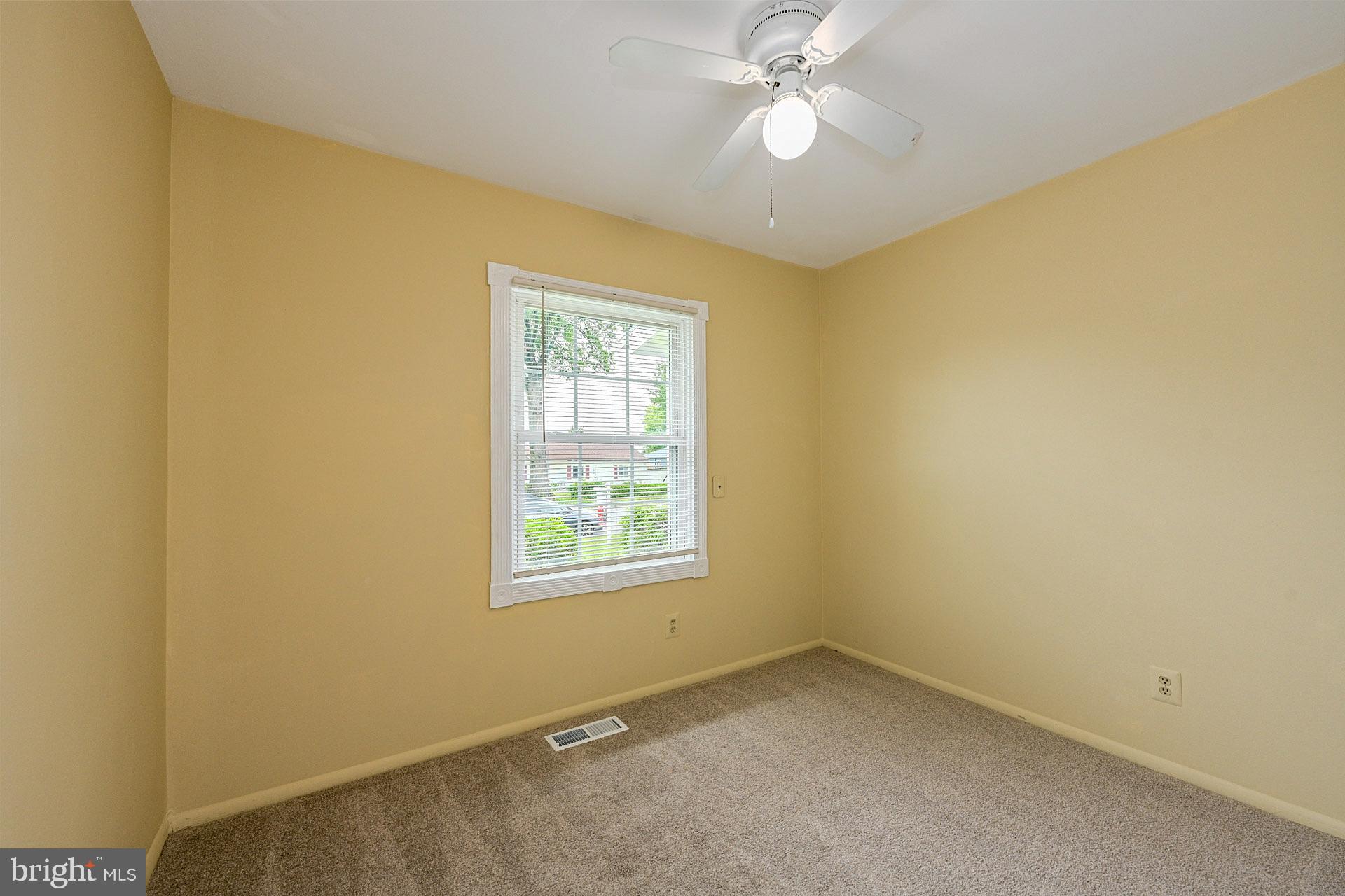 6728 Bowie Drive Springfield, VA 22150 - Photo 18 of 26 an empty room with a window and a fan