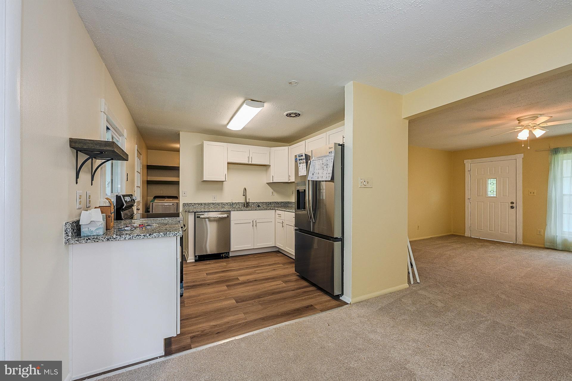 6728 Bowie Drive Springfield, VA 22150 - Photo 7 of 26 a kitchen with a refrigerator and a sink