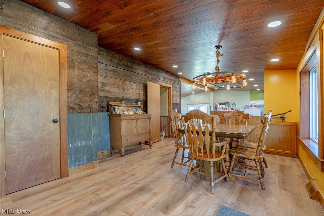 5267 Apollo Road Northeast Salineville, OH 43945 - Photo 7 of 33 Dining area with light wood finished floors, vaulted ceiling, wood walls, recessed lighting, and wooden ceiling