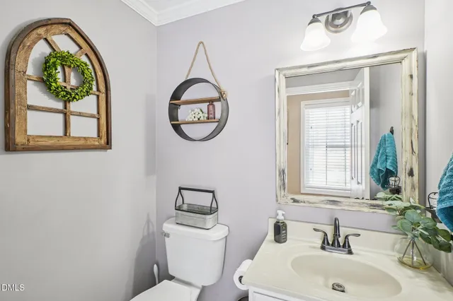a bathroom with a toilet a sink and a large mirror