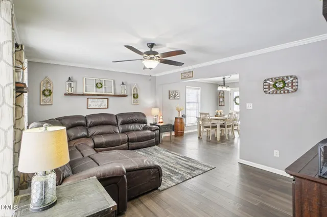 a living room with furniture and wooden floor
