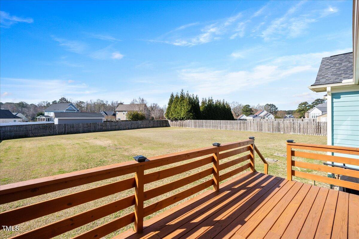 2117 Conroy Way Willow Spring, NC 27592 - Photo 17 of 38 Grilling deck just off the screen porch overlooking the fenced in backyard