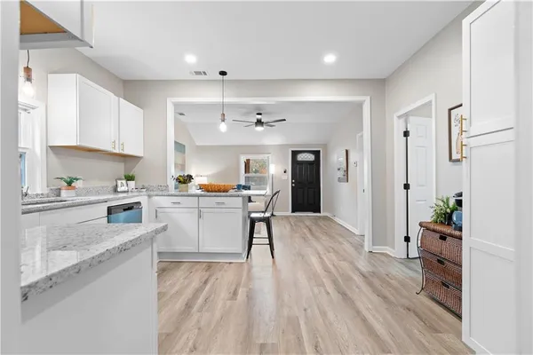a kitchen with white cabinets and counter space