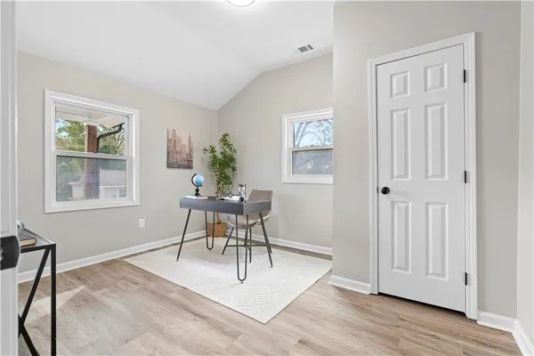a living room with furniture a window and a potted plant