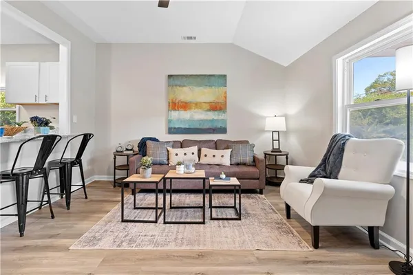 a living room with furniture and wooden floor