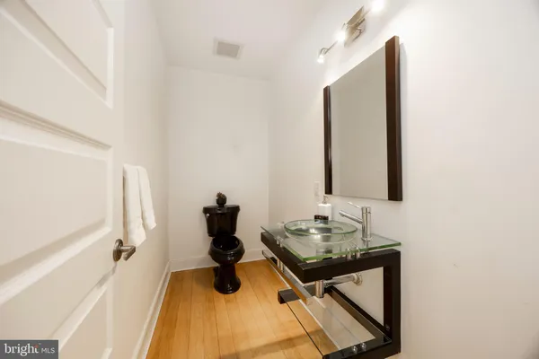 a bathroom with a sink mirror and vanity