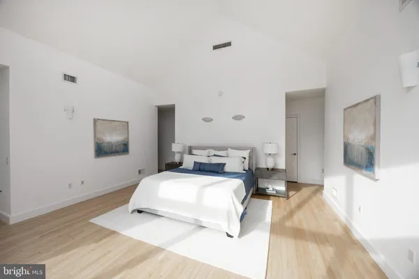 a bedroom with a bed and flat screen tv