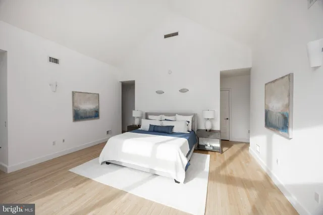 a bedroom with a bed and flat screen tv