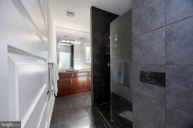 a bathroom with a glass door shower