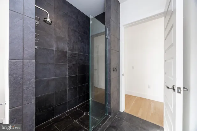 a bathroom with a glass shower door