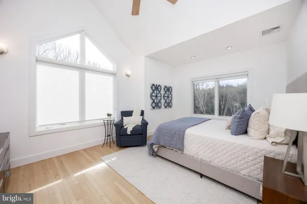 a bedroom with a bed couch and window