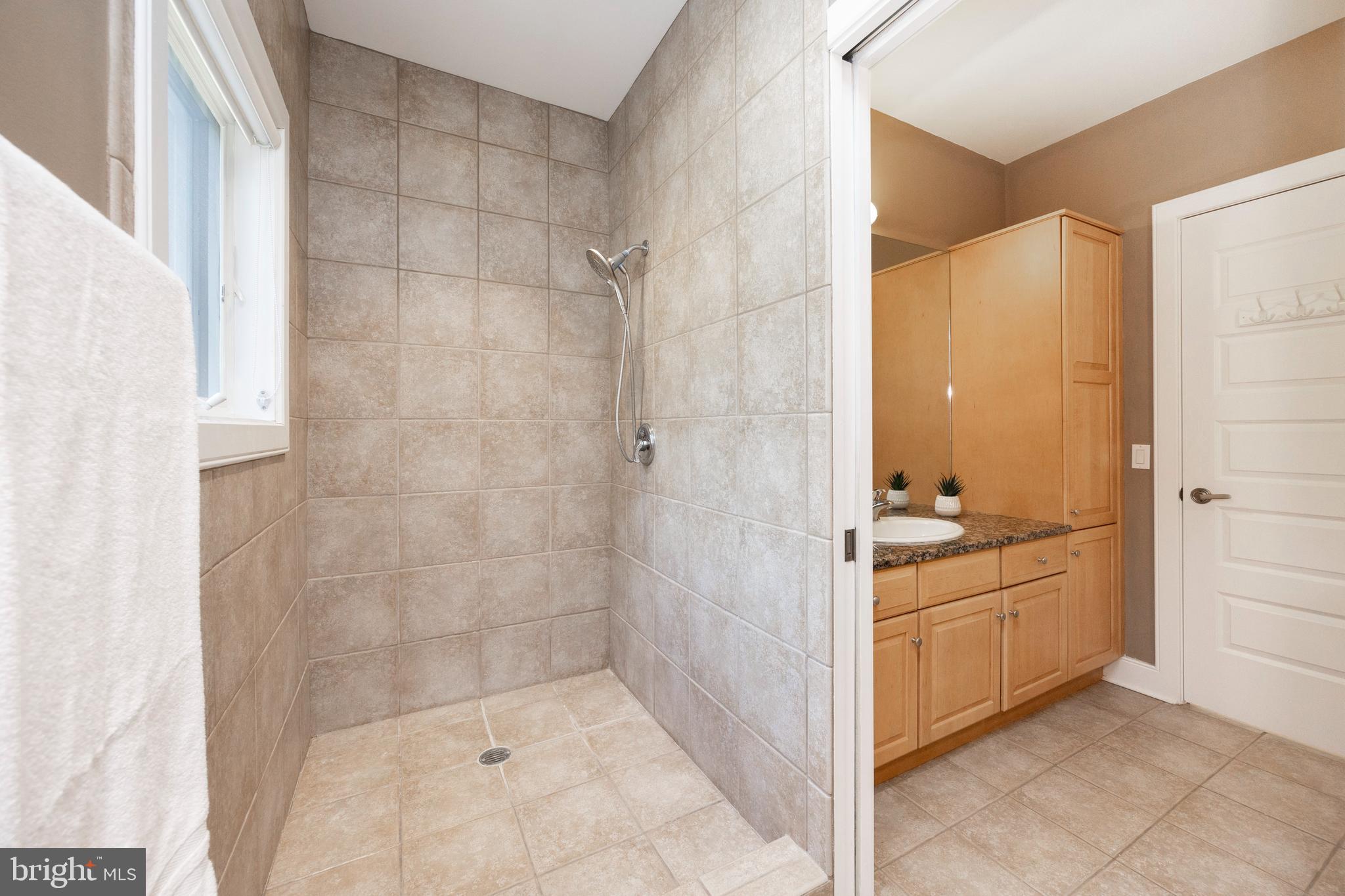 115 Bullock Road Chadds Ford, PA 19317 - Photo 31 of 50 a bathroom with a granite countertop sink a mirror and shower