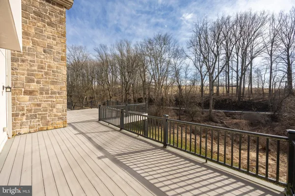 a view of balcony with wooden floor and fence