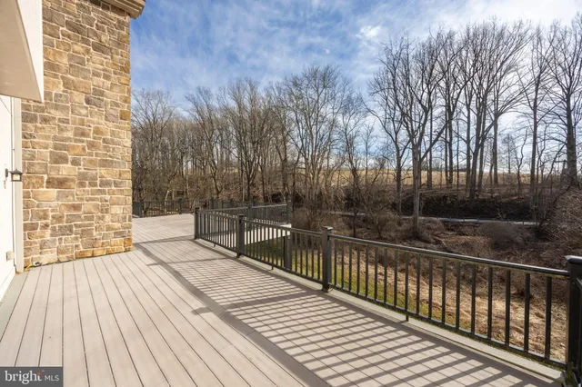 a view of balcony with wooden floor and fence