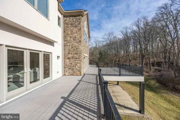 a view of balcony with wooden floor and fence