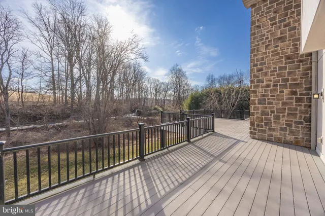 a view of balcony with wooden floor and fence