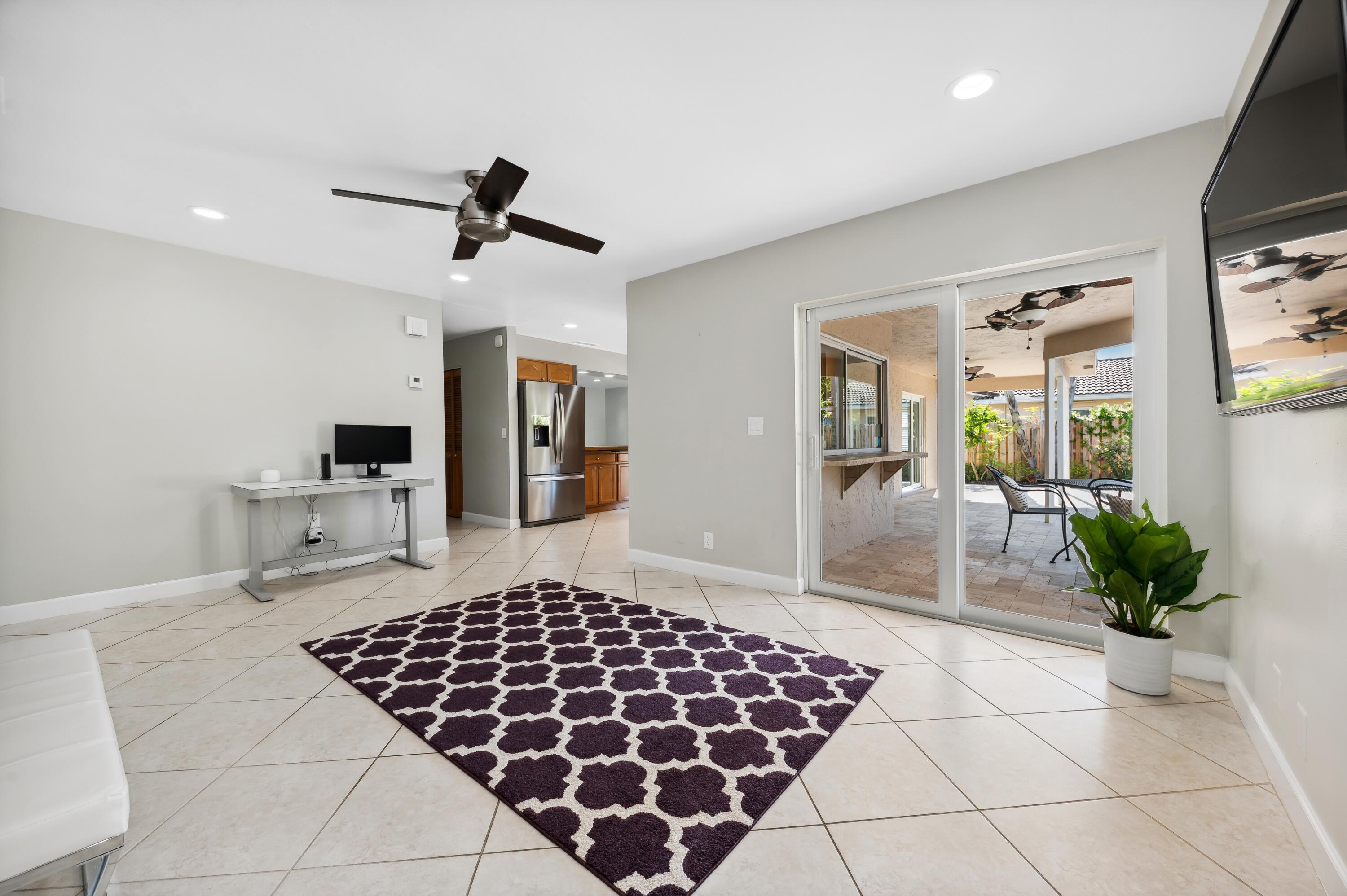 2382 Northwest 30th Road Boca Raton, FL 33431 - Photo 9 of 16 05_2382NW30thRd_94_FamilyRoomKitchen_HiR