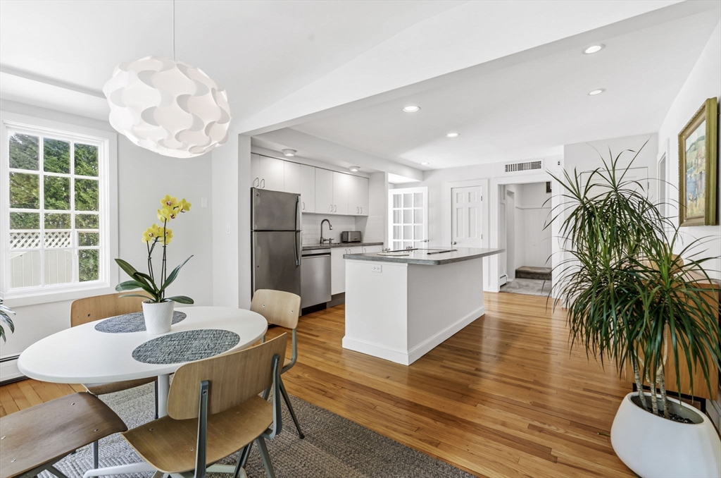 58 Front Street Northampton, MA 01053 - Photo 13 of 42 a kitchen with stainless steel appliances a dining table chairs and couches with wooden floor