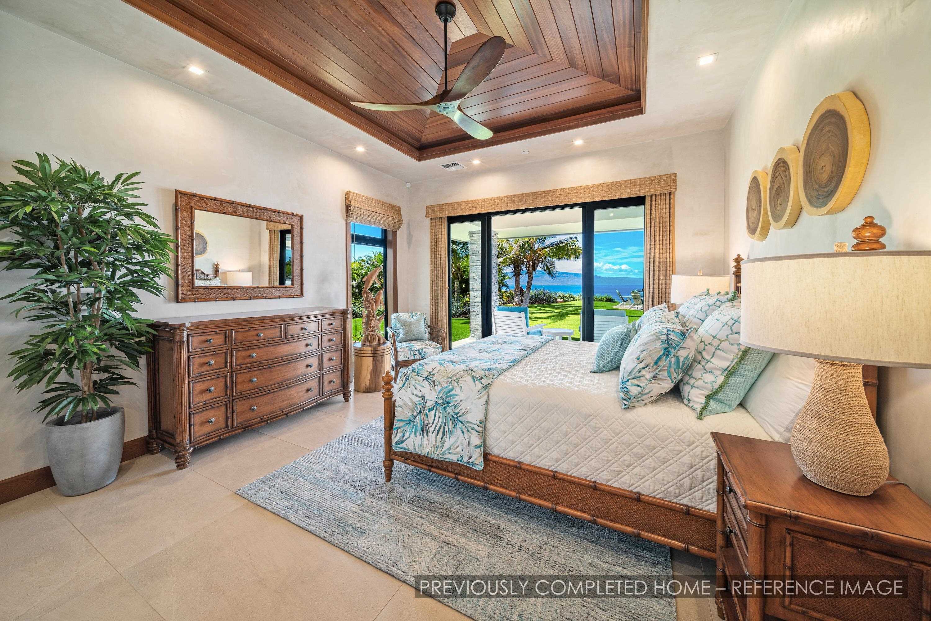 91 Kumu Niu Place, Unit A Lahaina, HI 96761 - Photo 11 of 48 a bedroom with a large bed and a chandelier
