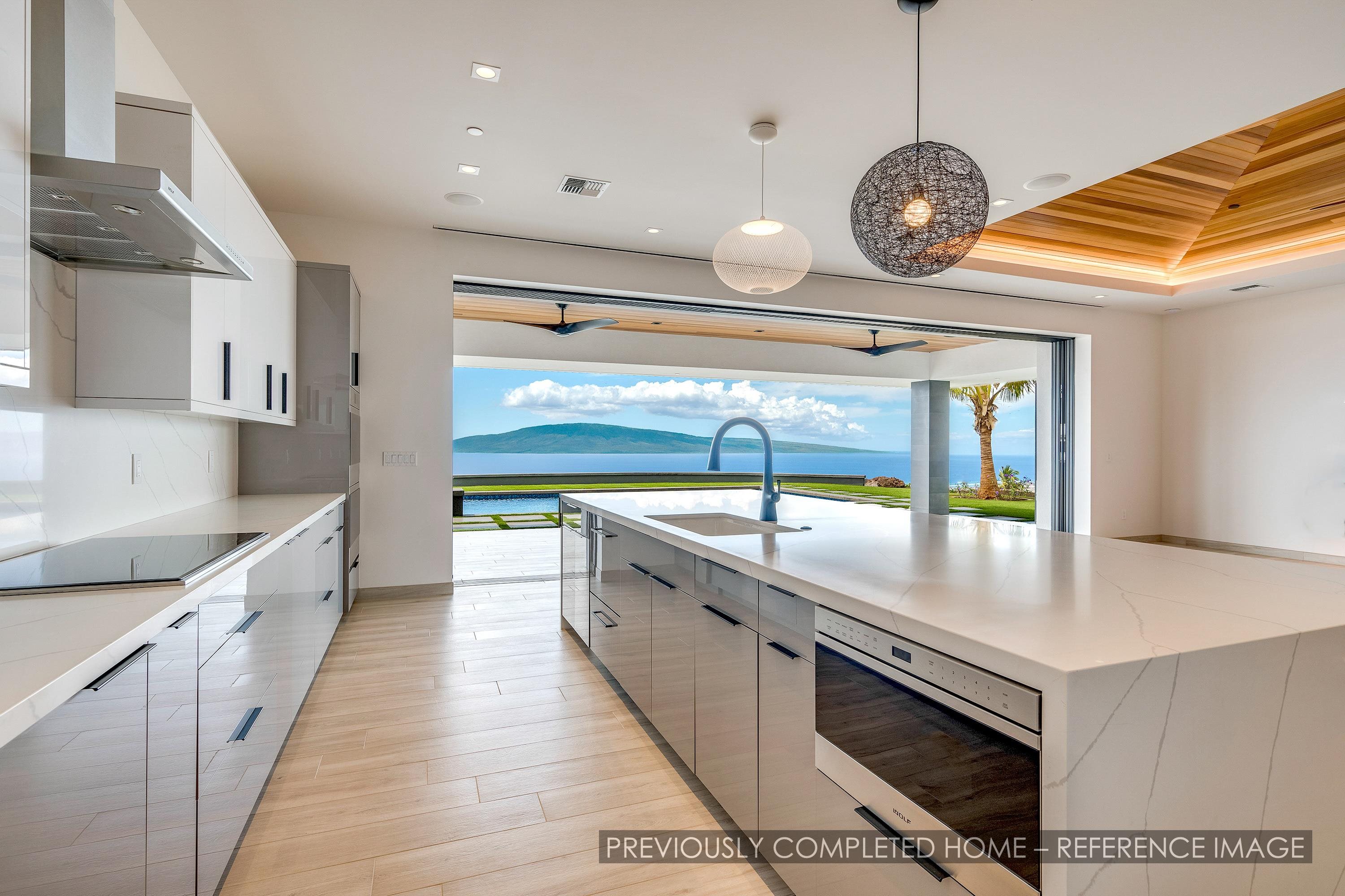 91 Kumu Niu Place, Unit A Lahaina, HI 96761 - Photo 4 of 48 a large kitchen with stainless steel appliances a large counter top a stove and a sink