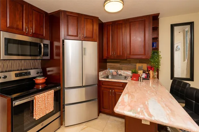 a kitchen with a refrigerator stove and cabinets