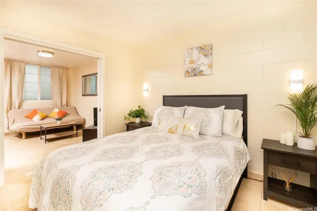 a bedroom with bed and a couch