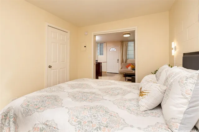 a bedroom with a bed and a mirror