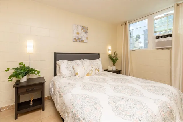 a bedroom with a bed and a painting on the wall