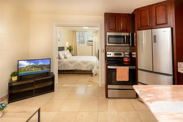 a kitchen with stainless steel appliances kitchen island granite countertop a refrigerator stove and oven