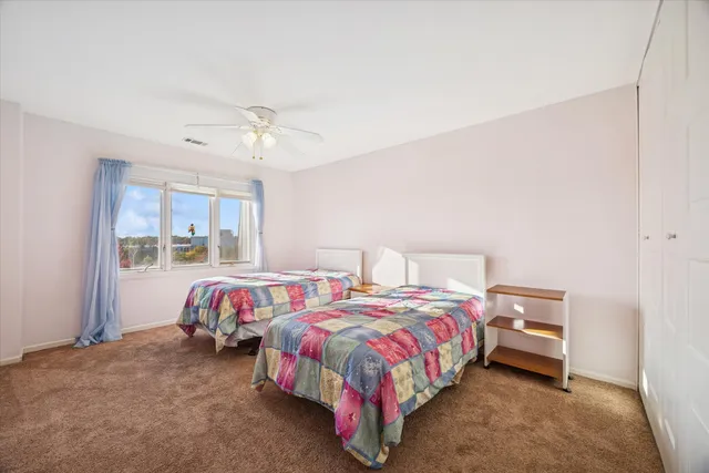 a bedroom with two beds and window