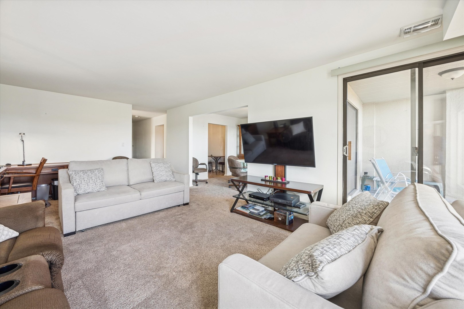 453 Raintree Drive, Unit 5A Glen Ellyn, IL 60137 - Photo 5 of 16 a living room with furniture and a flat screen tv