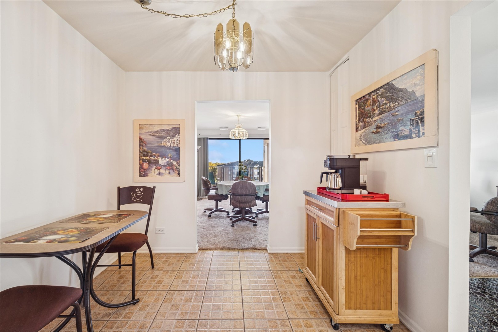 453 Raintree Drive, Unit 5A Glen Ellyn, IL 60137 - Photo 7 of 16 a living room with a couch and a chandelier