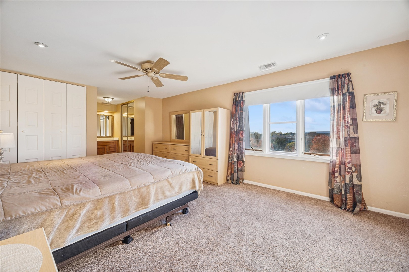 453 Raintree Drive, Unit 5A Glen Ellyn, IL 60137 - Photo 9 of 16 a spacious bedroom with a bed and a chandelier