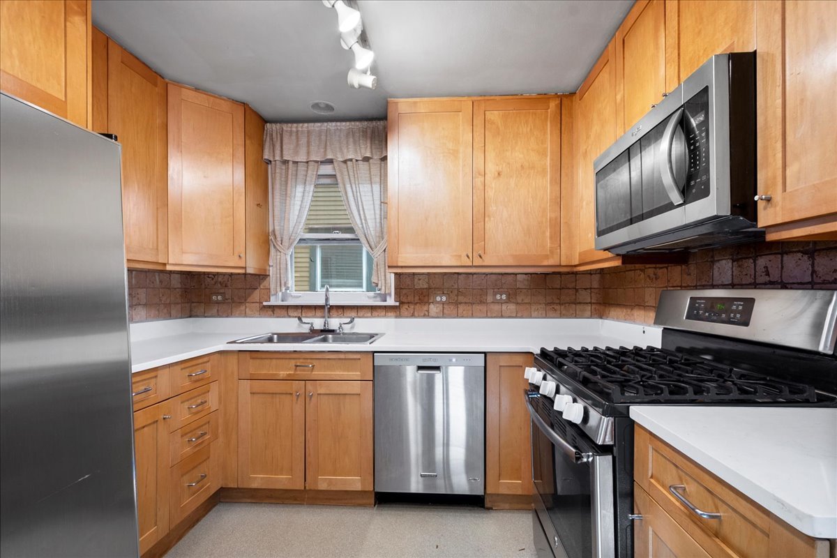 524 Hamilton Street Evanston, IL 60202 - Photo 10 of 32 a kitchen with cabinets appliances a sink and a window