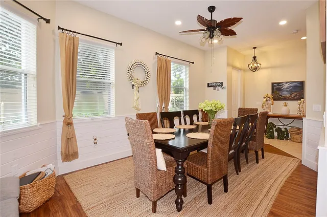 a view of a a dining room with furniture window and wooden floor