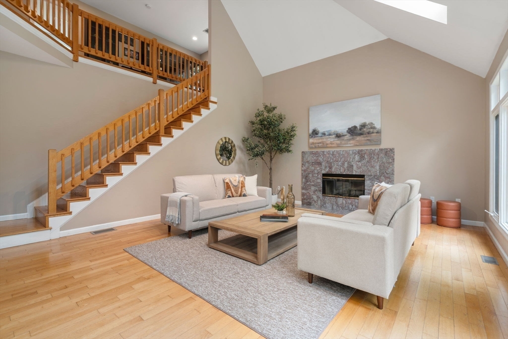 11 Black Elk Road Sharon, MA 02067 - Photo 13 of 28 a living room with furniture and a fireplace